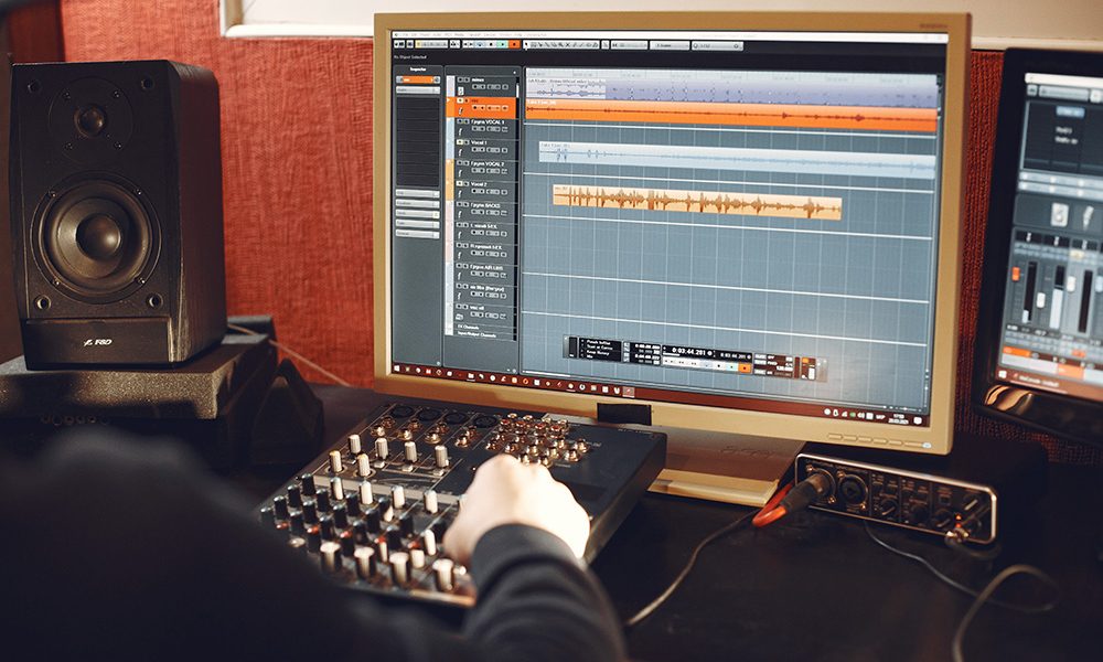 Man working in a studio with a sound recording equipment