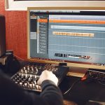 Man working in a studio with a sound recording equipment