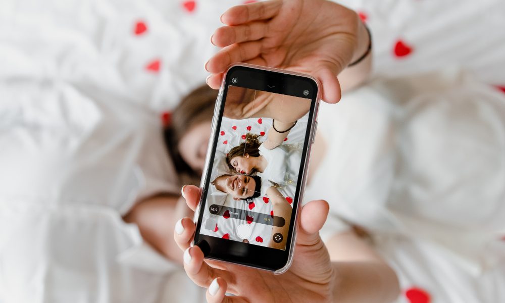 Phone screen with selfie of man and woman