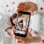Phone screen with selfie of man and woman