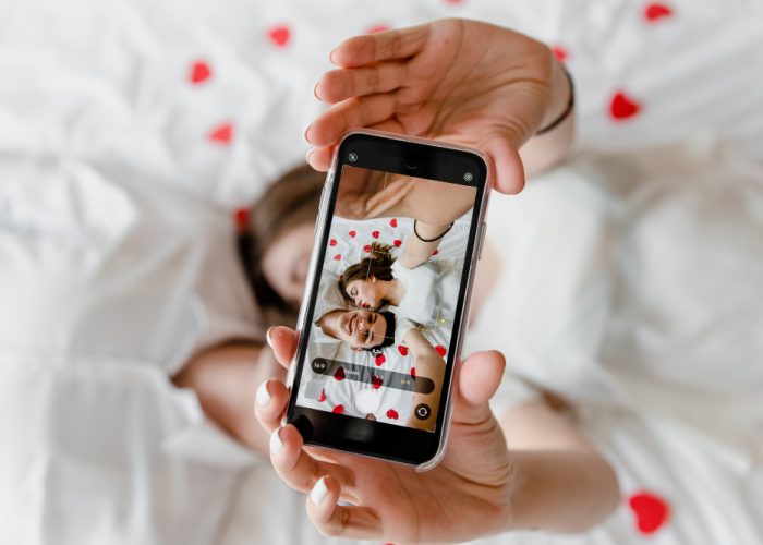Phone screen with selfie of man and woman