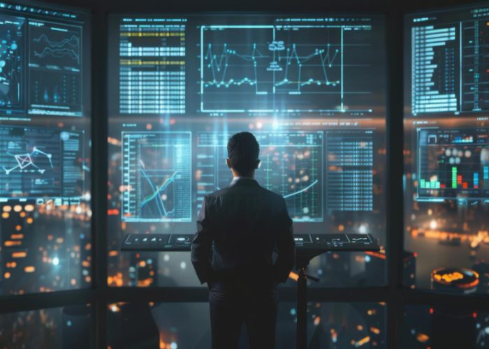 A businessman analyzing data on multiple screens in a hightech office