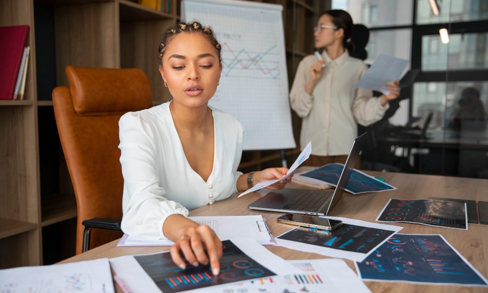 Office workers using finance graphs