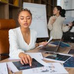 Office workers using finance graphs