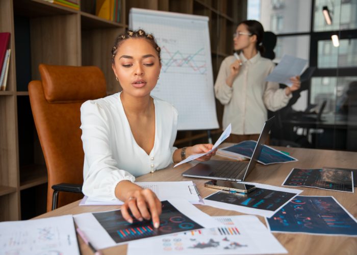 Office workers using finance graphs