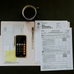 black Android smartphone near ballpoint pen